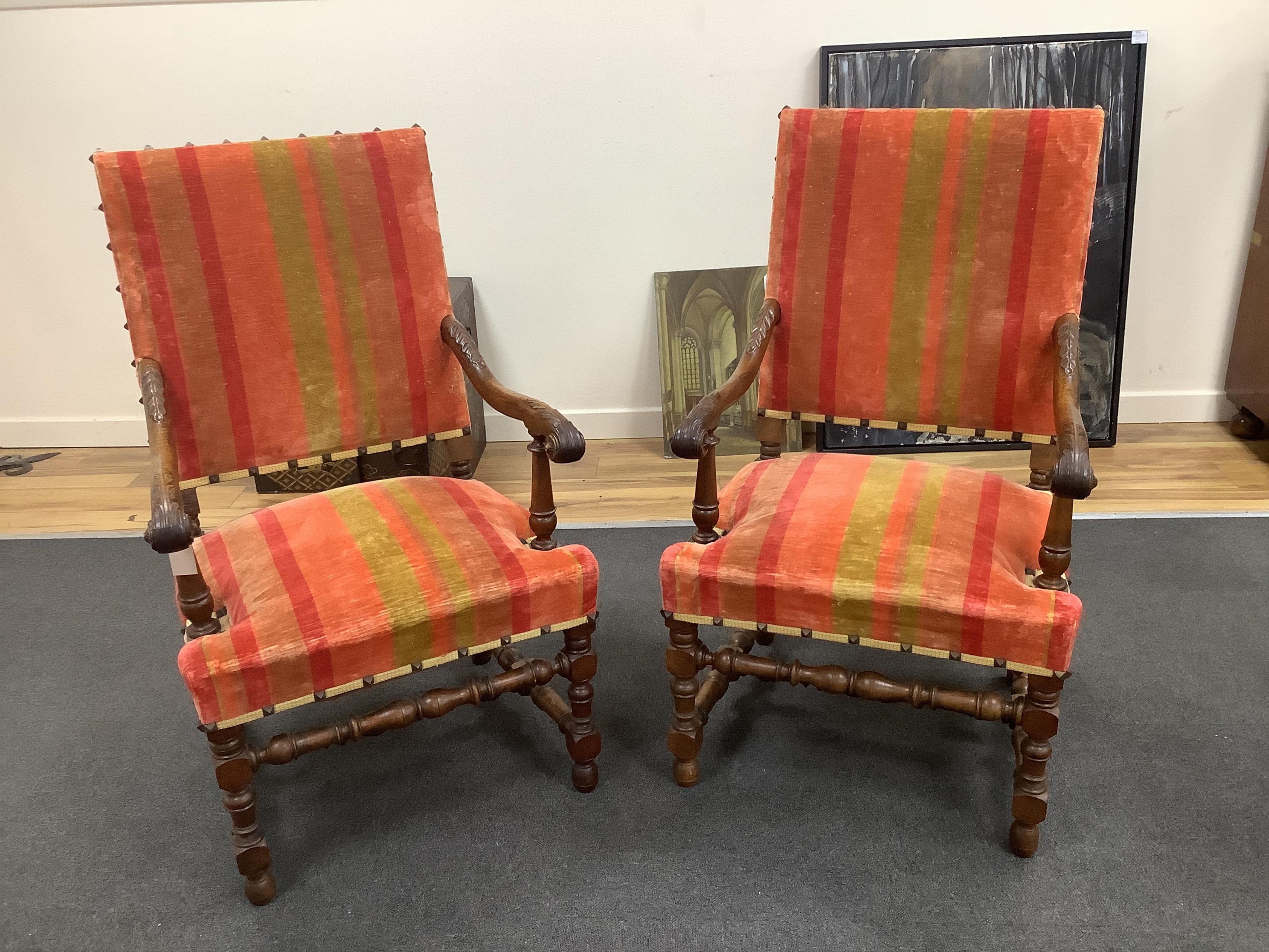 A pair of French walnut elbow chairs, width 65cm, depth 55cm, height 110cm. Condition - fair